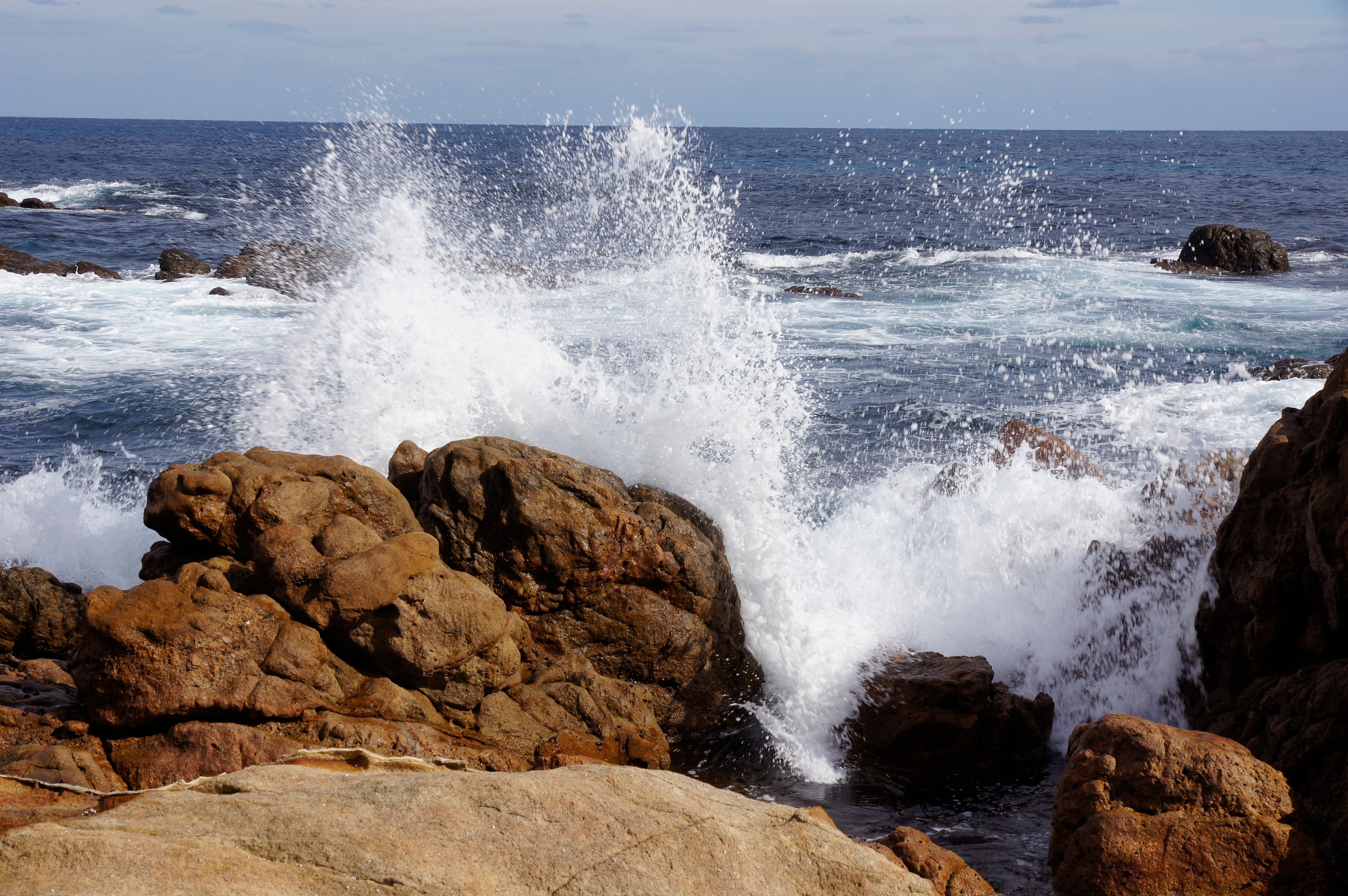 Waves crashing against rocks on a coastal landscape