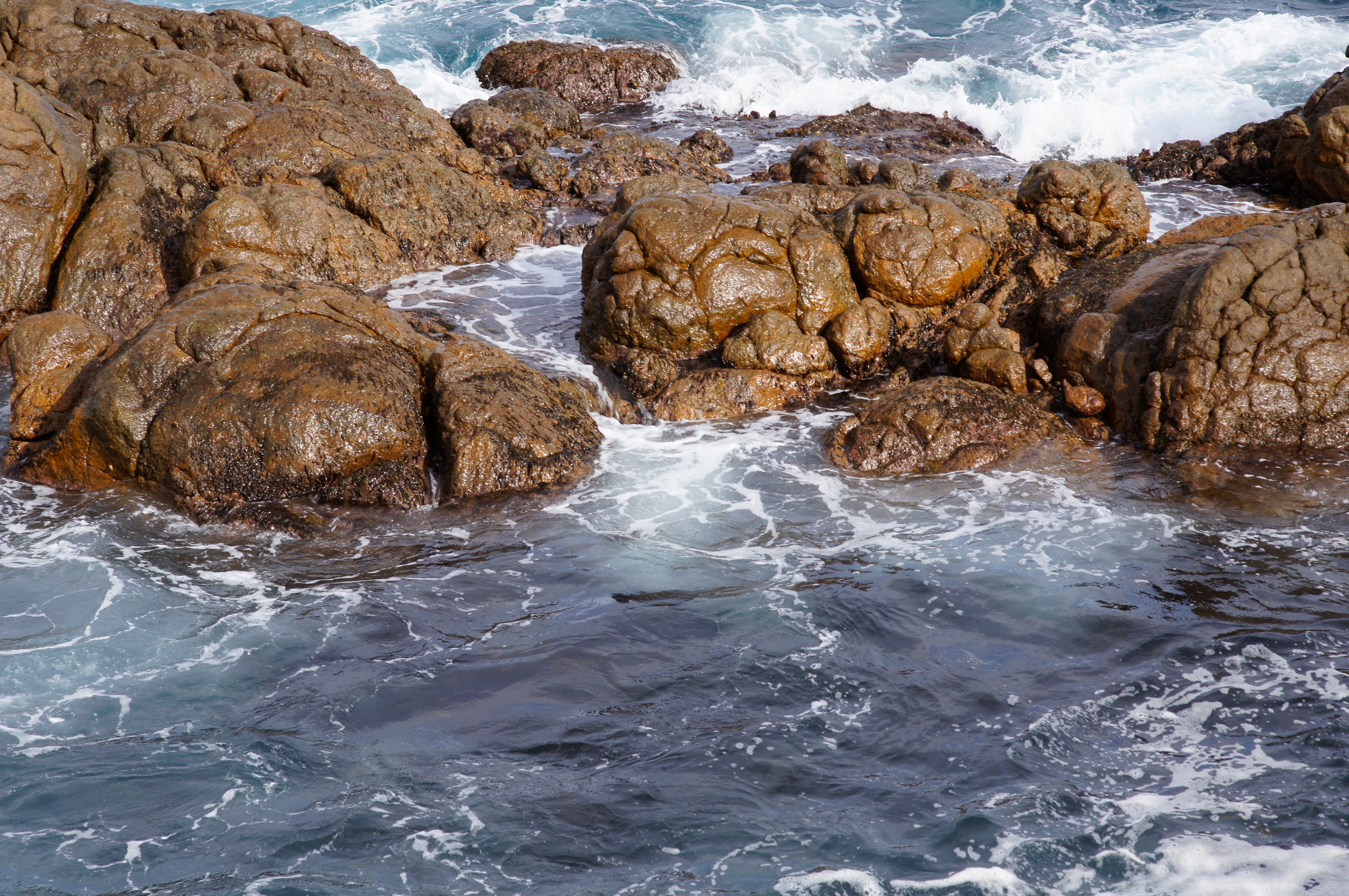 Rocks in the ocean with waves crashing against them